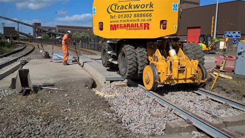 Corrosion protected rail crossing British Steel
