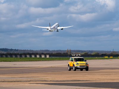 Gulf Air departing 27L with an airfield operations car driving