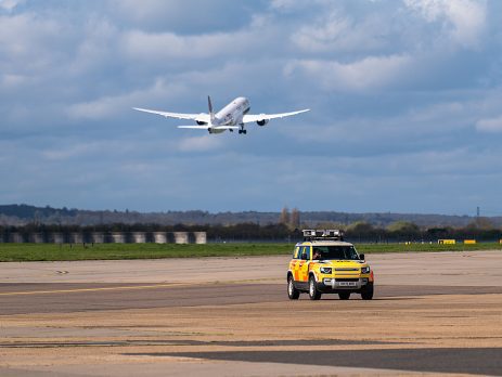 Gulf Air departing 27L with an airfield operations car driving
