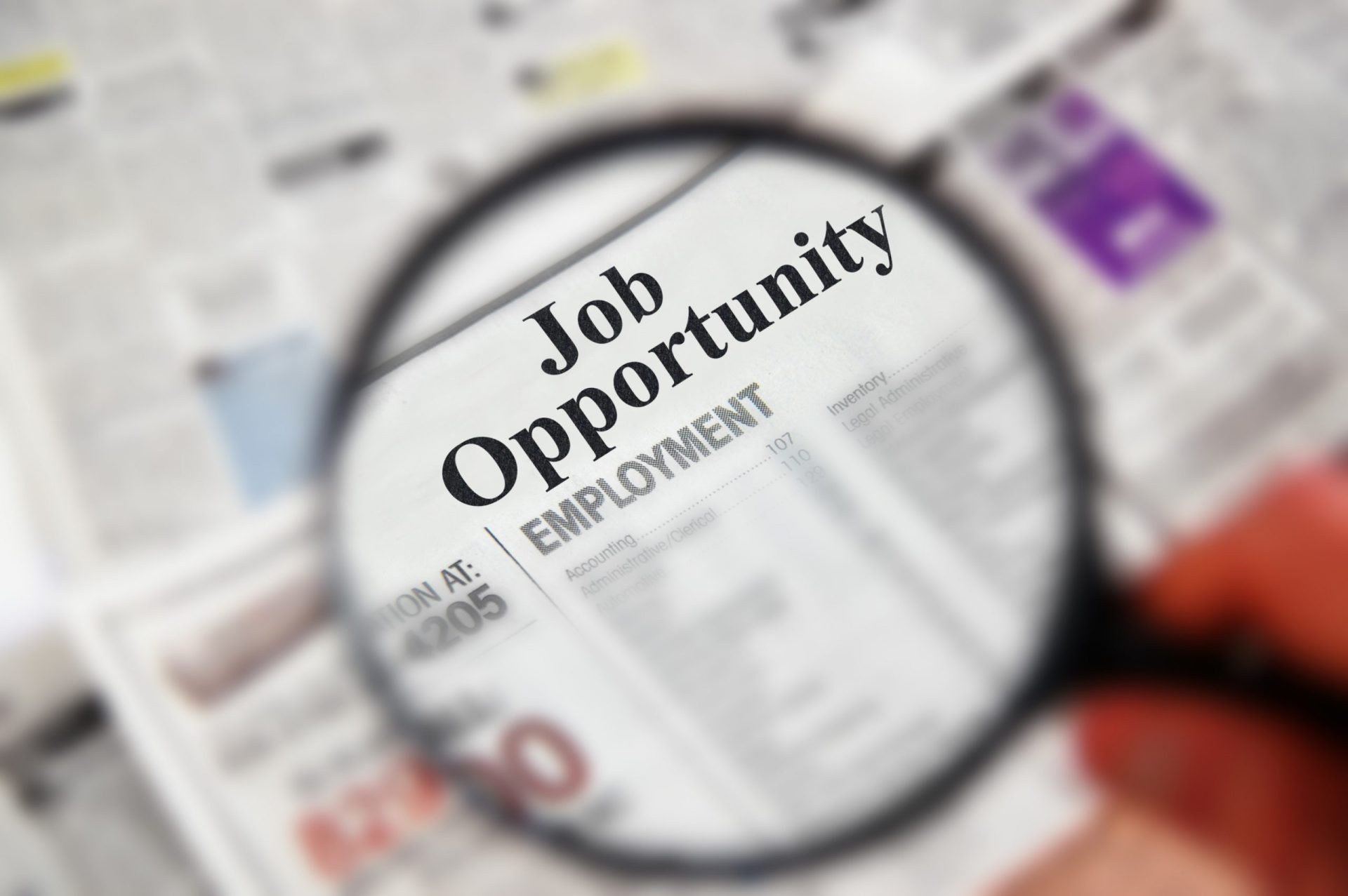 Magnifying glass focusing on classifieds section